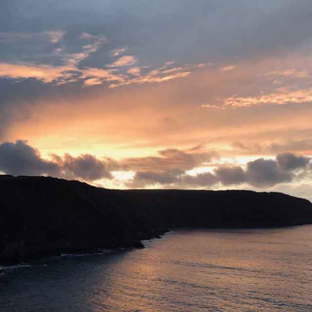 Sun setting on headland